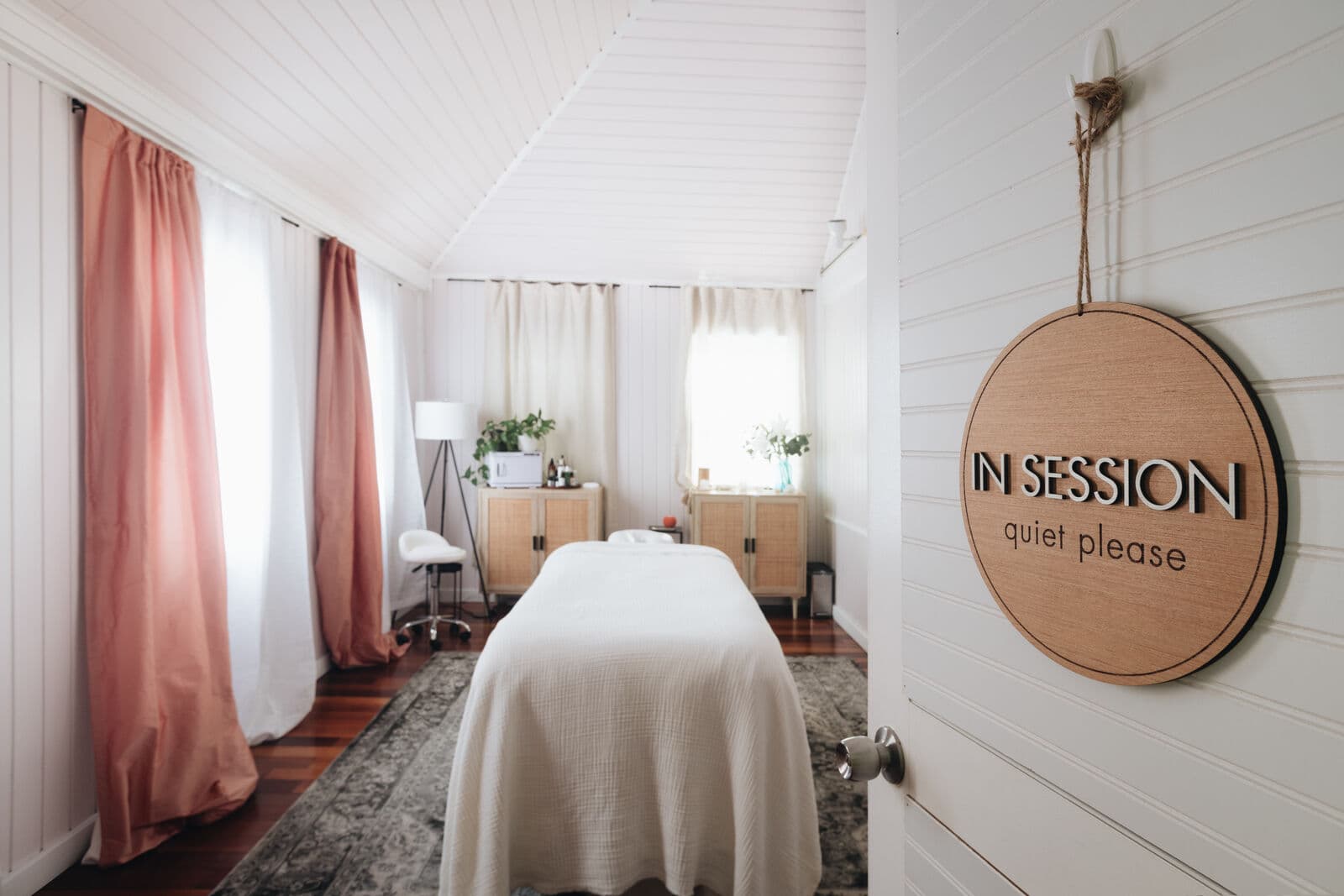 Treatment room with white shiplap walls and linen